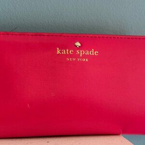 Kate Spade Cedar Street Stacy slim bifold wallet in a pink ombré patent leather